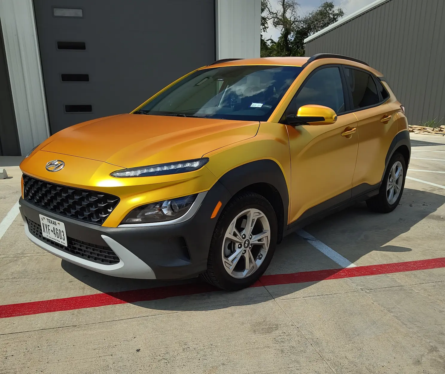 Energetic yellow wrap on a Hyundai Kona — Austin TX